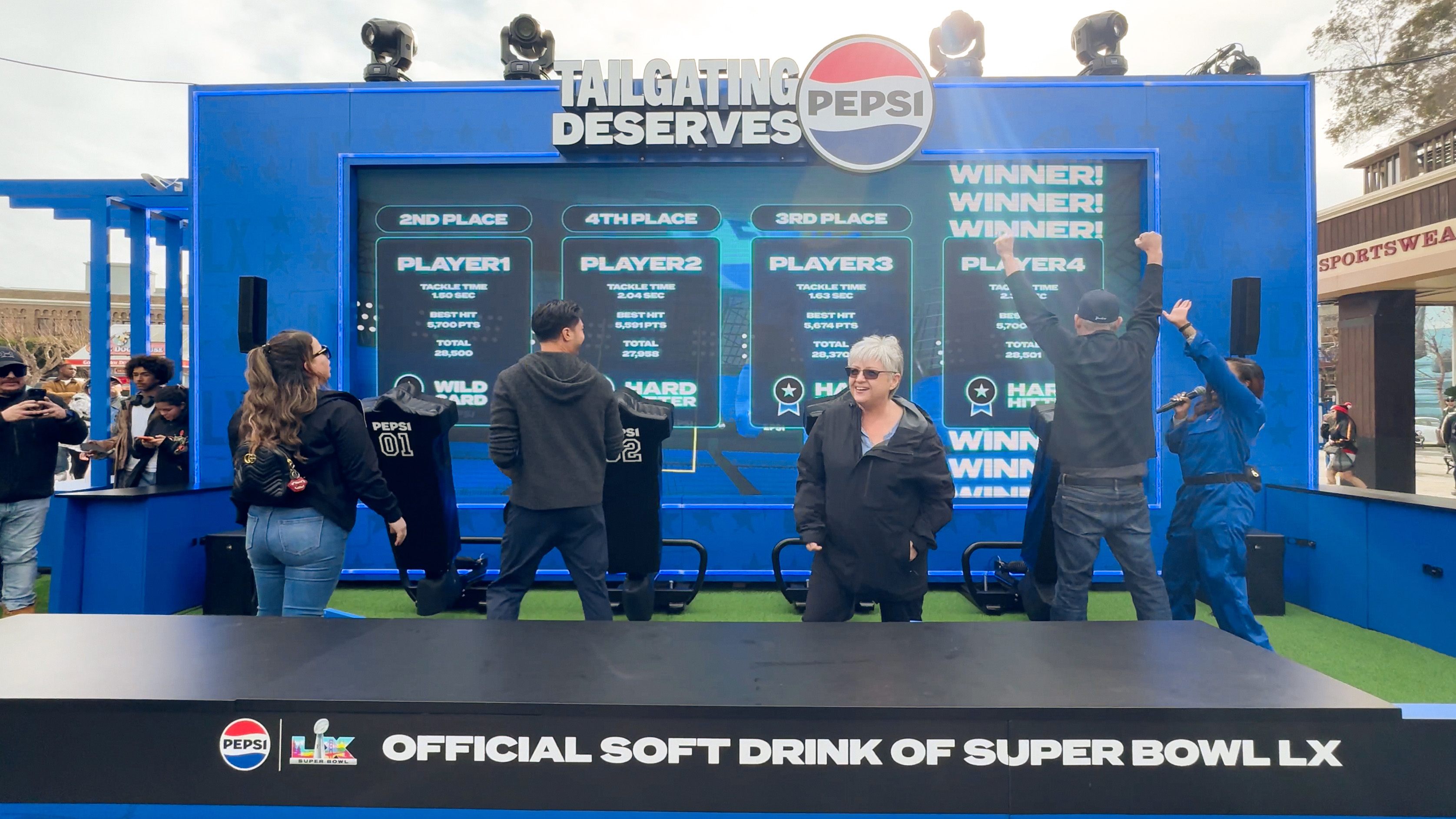 Pepsi interactive football game installation at Super Bowl LX brand activation, participants playing